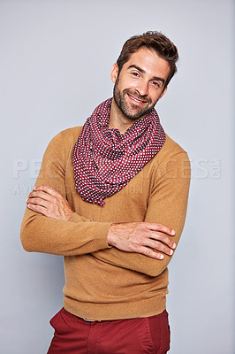 Buy stock photo Studio portrait of a handsome young man standing with his arms crossed against a grey background