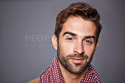 Buy stock photo Studio portrait of a handsome young man posing against a grey background