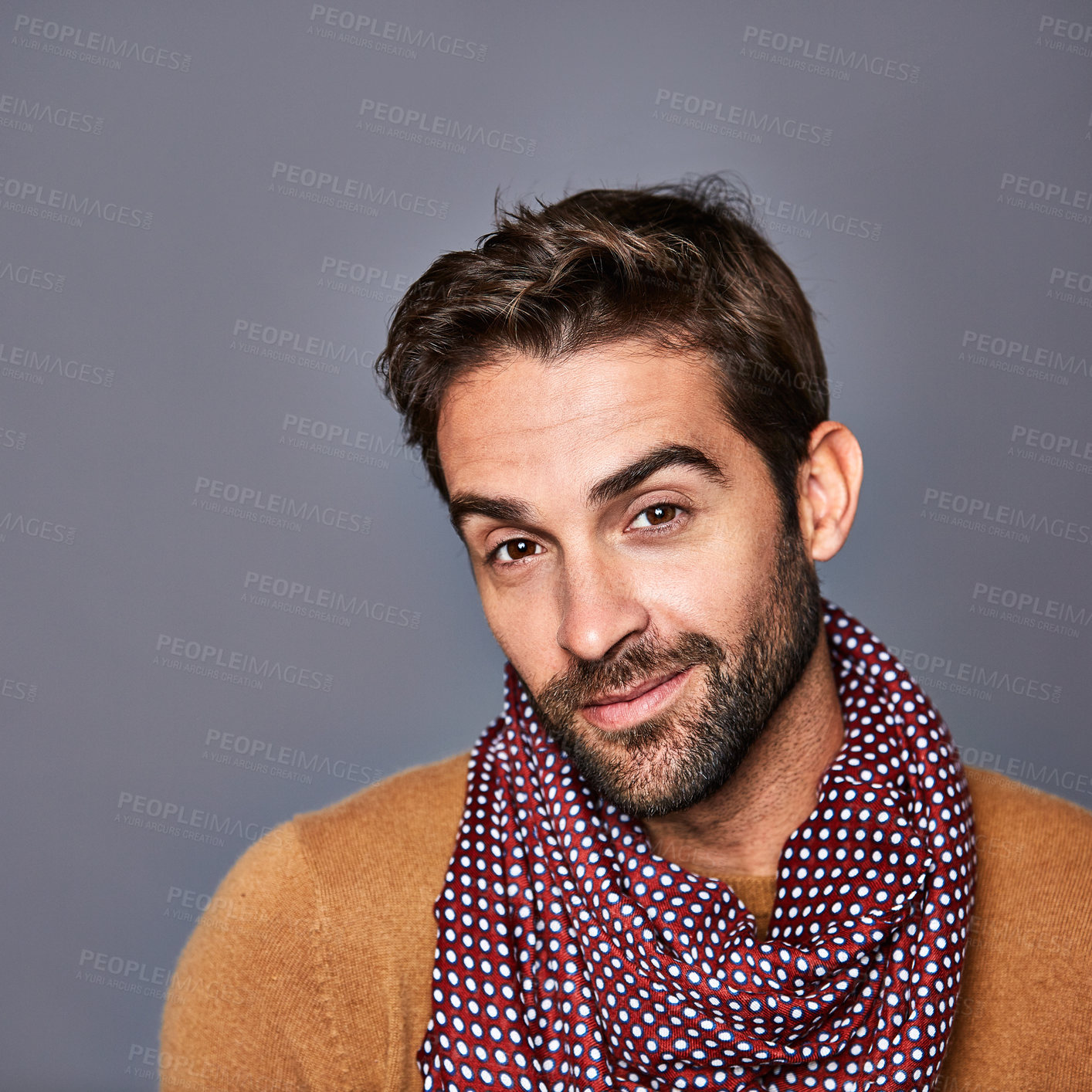 Buy stock photo Studio portrait of a handsome young man posing against a grey background