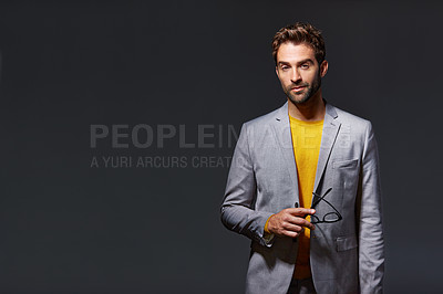 Buy stock photo Studio portrait of a handsome young businessman standing against a grey background