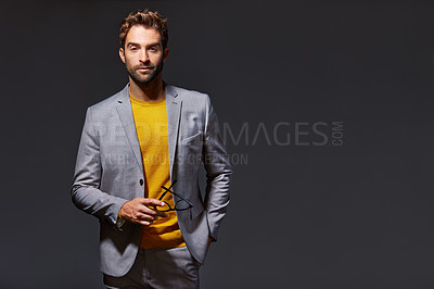 Buy stock photo Studio portrait of a handsome young businessman standing against a grey background