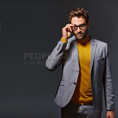 Buy stock photo Studio portrait of a handsome young businessman standing against a grey background