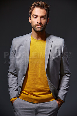 Buy stock photo Studio portrait of a handsome young businessman standing against a grey background