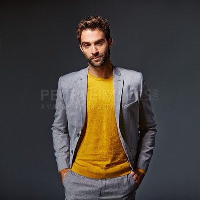 Buy stock photo Studio portrait of a handsome young businessman standing against a grey background