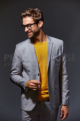 Buy stock photo Studio shot of a handsome young businessman standing against a grey background