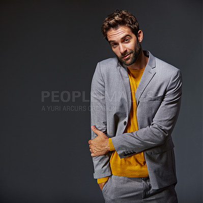 Buy stock photo Studio portrait of a handsome young businessman standing against a grey background