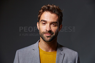 Buy stock photo Studio portrait of a handsome young businessman standing against a grey background