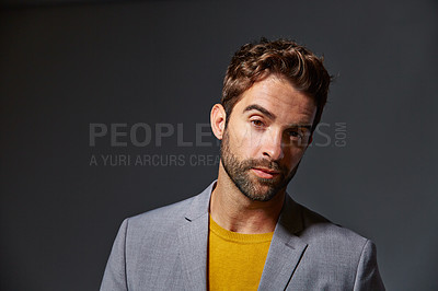 Buy stock photo Studio portrait of a handsome young businessman standing against a grey background
