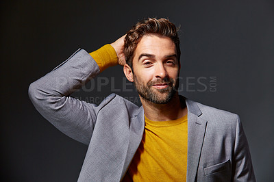 Buy stock photo Studio portrait of a handsome young businessman standing against a grey background