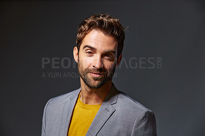 Buy stock photo Studio portrait of a handsome young businessman standing against a grey background