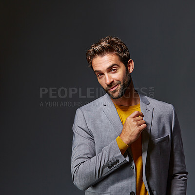 Buy stock photo Studio portrait of a handsome young businessman standing against a grey background