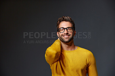 Buy stock photo Studio portrait of a handsome young man posing against a grey background