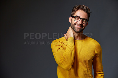 Buy stock photo Studio portrait of a handsome young man posing against a grey background