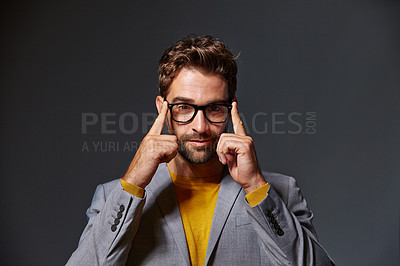 Buy stock photo Studio portrait of a handsome young businessman standing against a grey background
