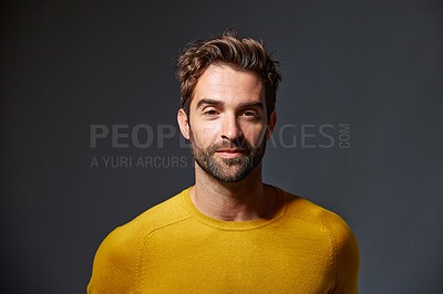 Buy stock photo Studio portrait of a handsome man posing against a grey background
