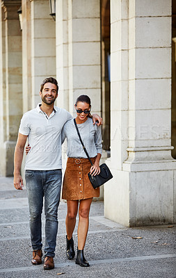 Buy stock photo Shot of an affectionate young couple exploring a foreign city