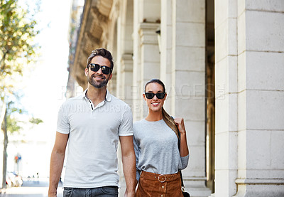 Buy stock photo Shot of an affectionate young couple exploring a foreign city
