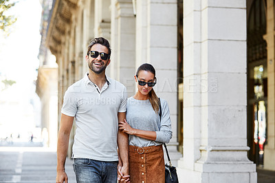 Buy stock photo Shot of an affectionate young couple exploring a foreign city