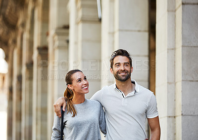 Buy stock photo Shot of an affectionate young couple exploring a foreign city