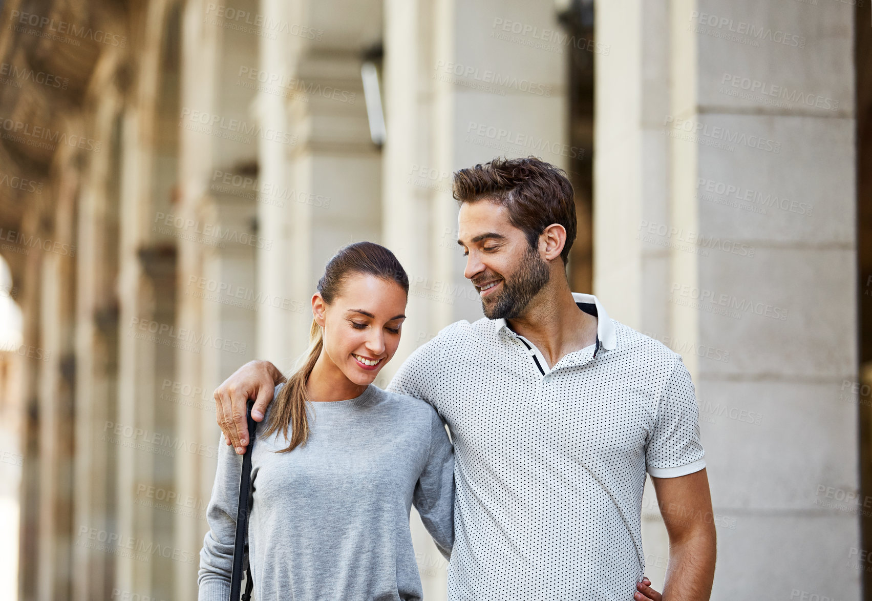 Buy stock photo Shot of an affectionate young couple exploring a foreign city