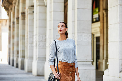 Buy stock photo Cropped shot of a young woman walking through the city