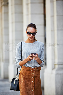 Buy stock photo Cropped shot of a young woman walking through the city