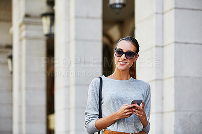 Buy stock photo Cropped shot of a young woman walking through the city