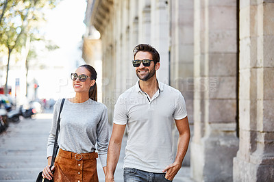 Buy stock photo Shot of an affectionate young couple exploring a foreign city