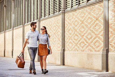 Buy stock photo Shot of an affectionate young couple exploring a foreign city