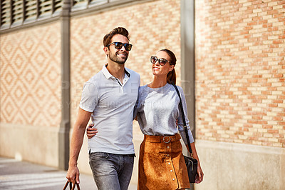 Buy stock photo Shot of an affectionate young couple exploring a foreign city