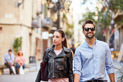 Buy stock photo Shot of an affectionate young couple exploring a foreign city