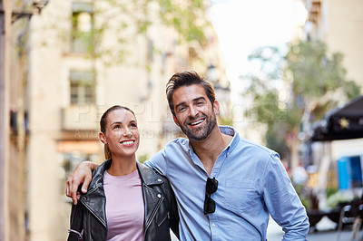 Buy stock photo Shot of an affectionate young couple exploring a foreign city