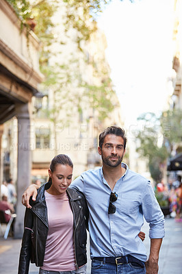 Buy stock photo Shot of an affectionate young couple exploring a foreign city