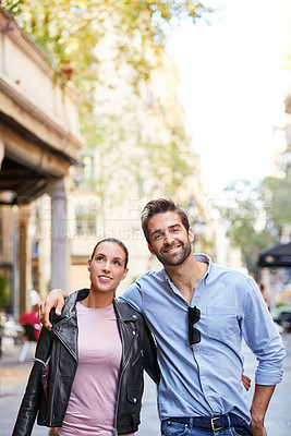 Buy stock photo Shot of an affectionate young couple exploring a foreign city