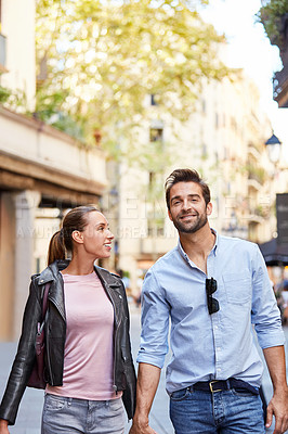 Buy stock photo Shot of an affectionate young couple exploring a foreign city