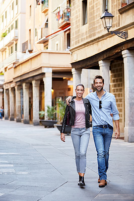 Buy stock photo Shot of an affectionate young couple exploring a foreign city