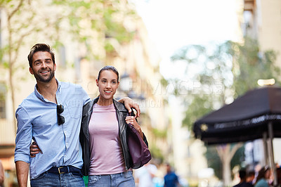 Buy stock photo Shot of an affectionate young couple exploring a foreign city