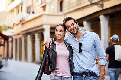 Buy stock photo Shot of an affectionate young couple exploring a foreign city
