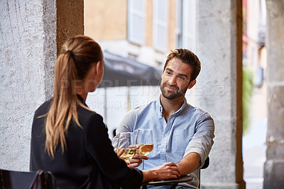 Buy stock photo Shot of a couple having wine outside at a restaurant
