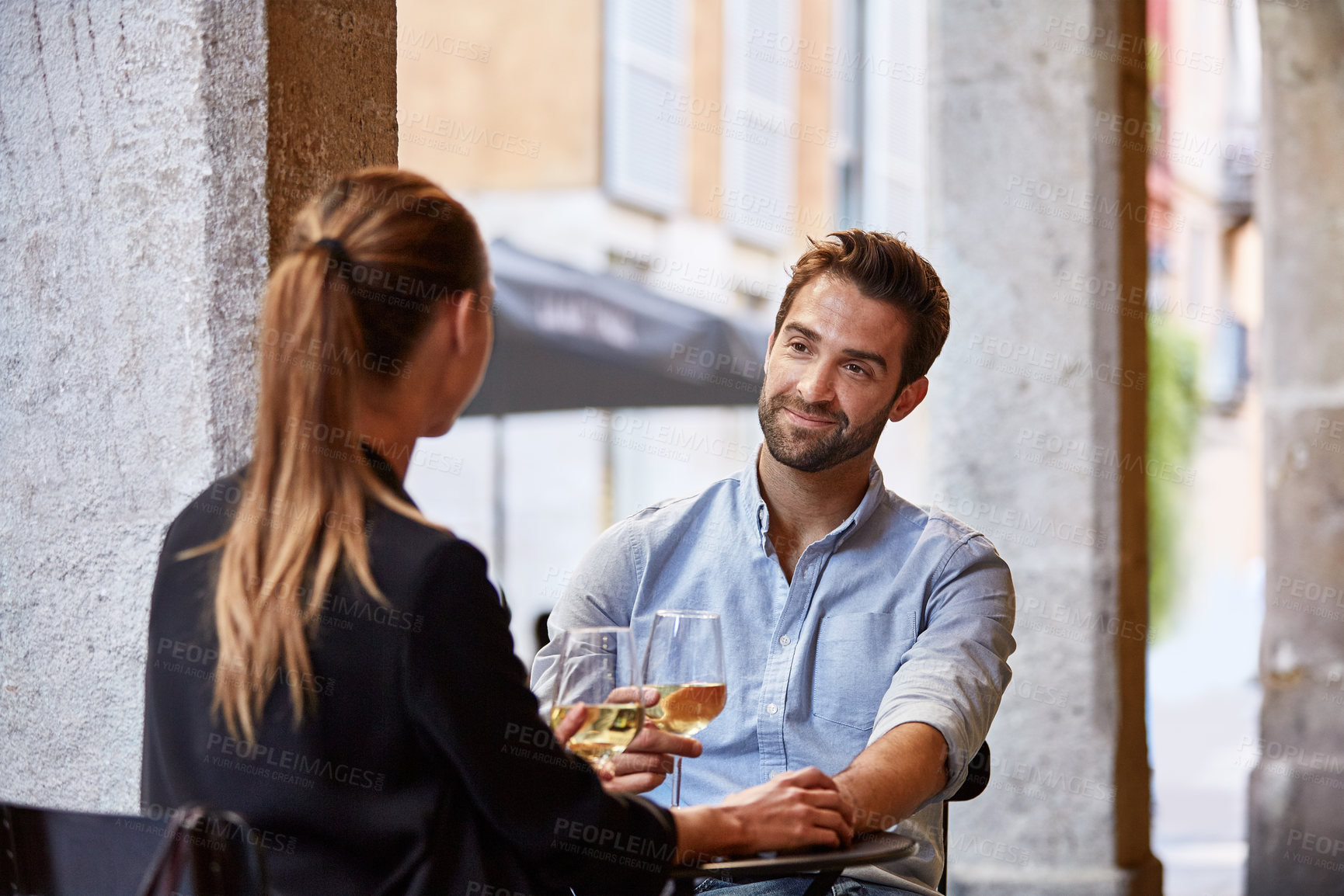 Buy stock photo Talking, couple and man with wine in restaurant for conversation, bonding and celebrate on date. Happy, marriage and people with alcohol for anniversary, relationship and valentines day outdoor
