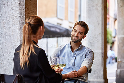 Buy stock photo Shot of a couple having wine outside at a restaurant