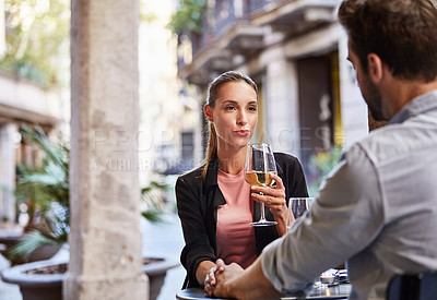 Buy stock photo Shot of a couple having wine outside at a restaurant