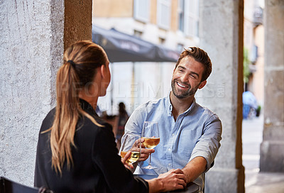 Buy stock photo Shot of a couple having wine outside at a restaurant