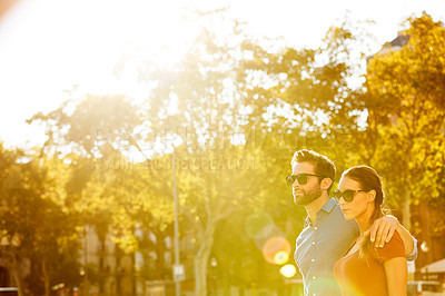 Buy stock photo Shot of a loving couple out in the city on a sunny day