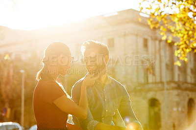 Buy stock photo Shot of a loving couple out in the city on a sunny day
