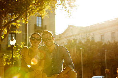Buy stock photo Shot of a loving couple out in the city on a sunny day