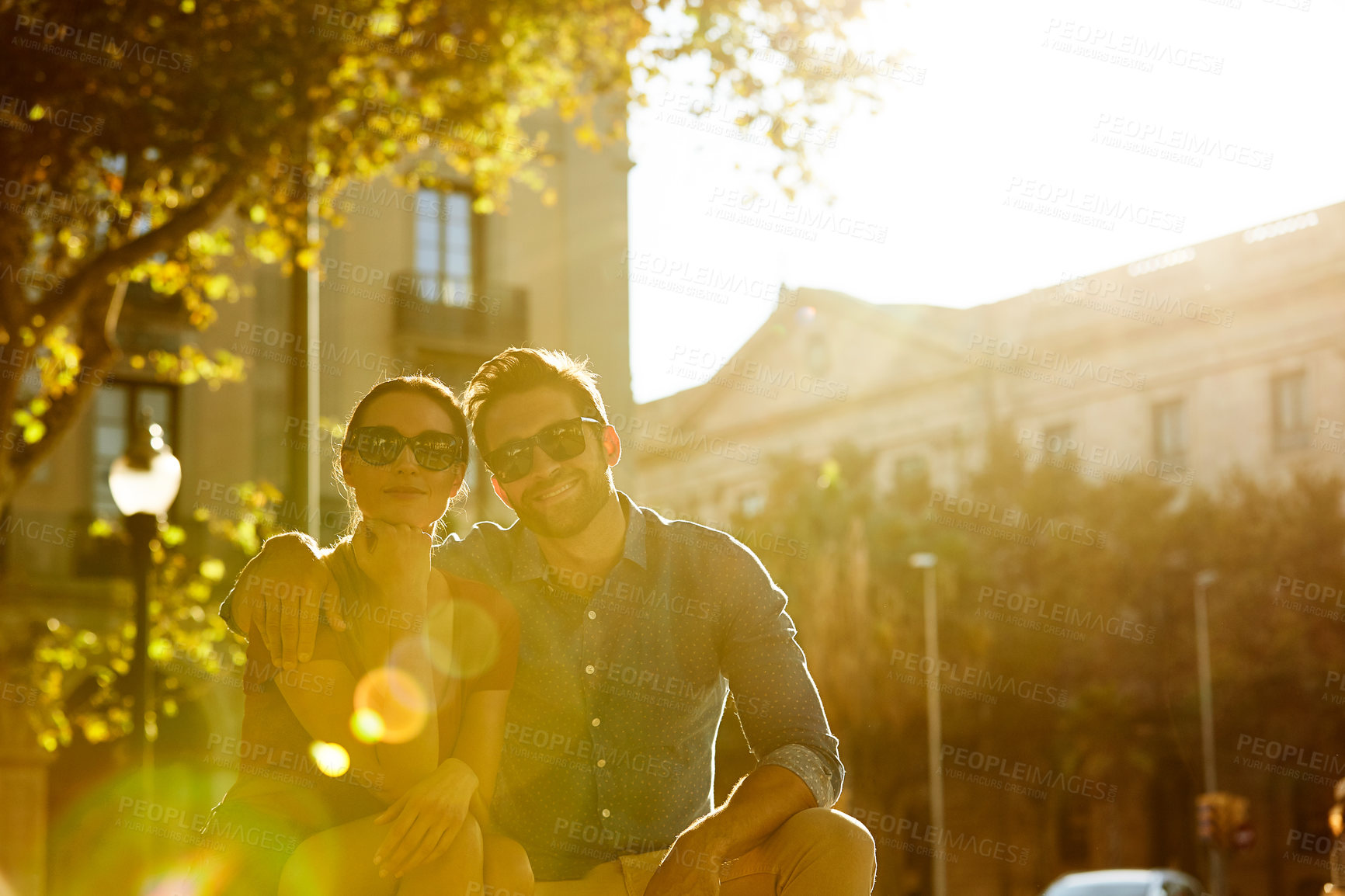 Buy stock photo Shot of a loving couple out in the city on a sunny day
