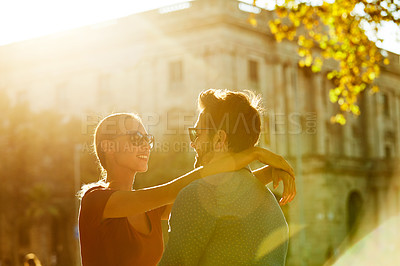 Buy stock photo Shot of a loving couple out in the city on a sunny day