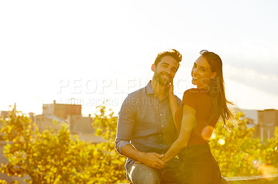 Buy stock photo Shot of a couple out on a rooftop for their date