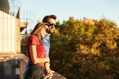 Buy stock photo Shot of an affectionate young couple exploring a foreign city